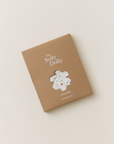 Solly Dolly in a kraft box with a floral cutout window revealing the dainty hand-painted strawberry vine fabric.