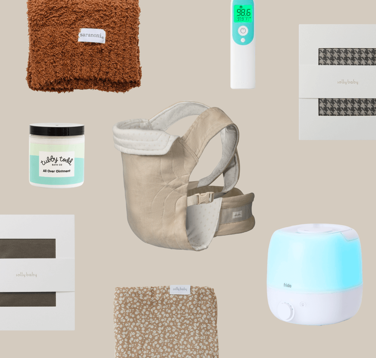 Collection of autumn baby essentials including a burnt orange fuzzy blanket, a Frida thermometer, boxed Solly Wraps in Stormy Houndstooth and Cacao, The Solly Soft Carrier in Oat heritage dot, and other things.