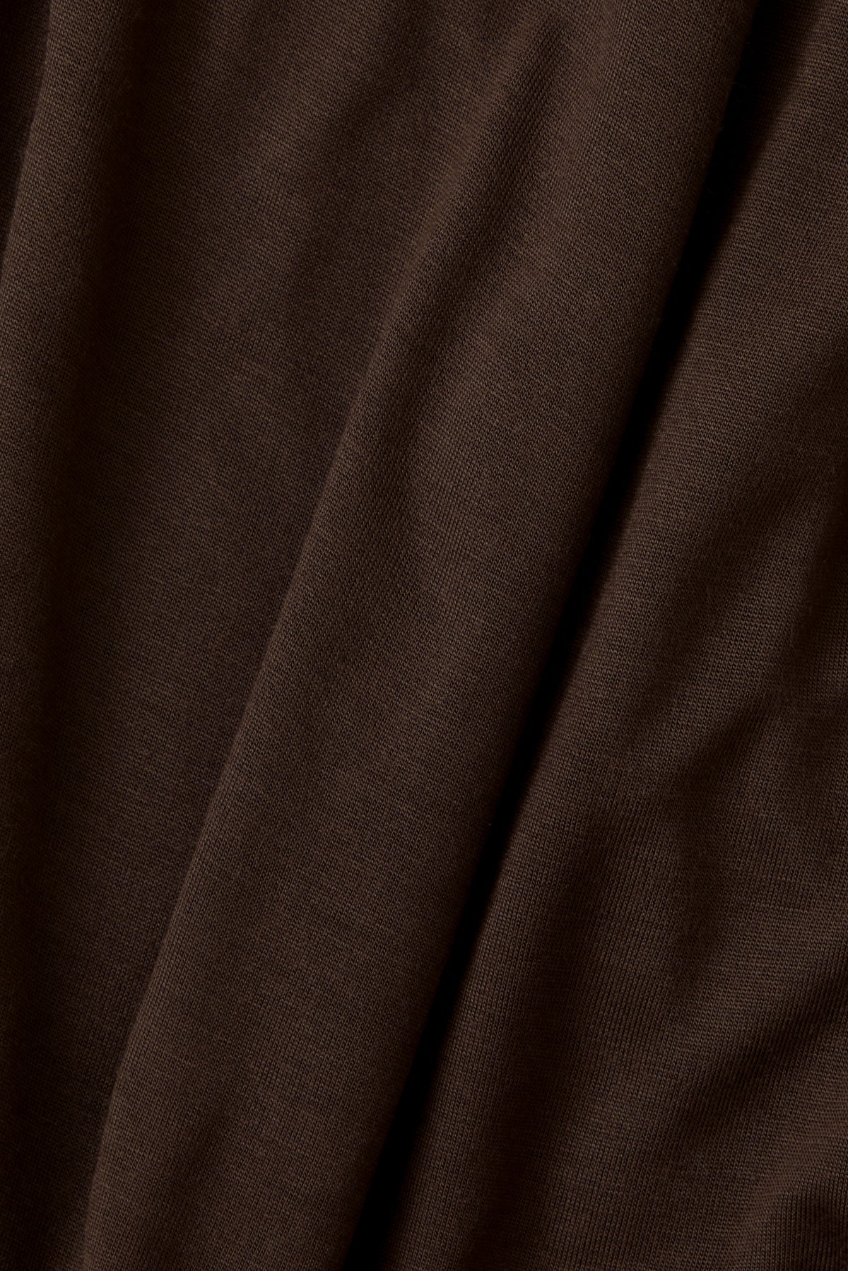 A close-up of draped dark brown fabric with soft folds and a fine knit texture.