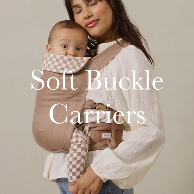 Woman holding a baby in a soft buckle carrier with text overlay on a beige background