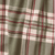 A close-up of a plaid fabric pattern with sage green, cream, burgundy, and dark brown stripes.
