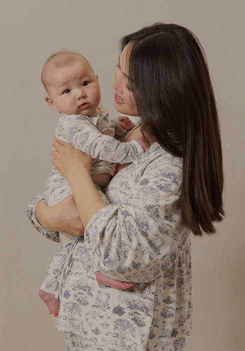 Mother and baby wearing coordinating Solly Baby pajamas in the timeless Toile design. Soft, breathable loungewear designed for family moments and restful nights.