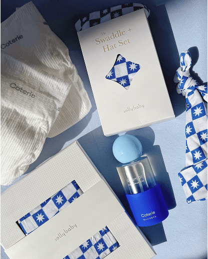 Baby product set including a bottle, packaging, and swaddle with blue and white checkered pattern on a light blue background.