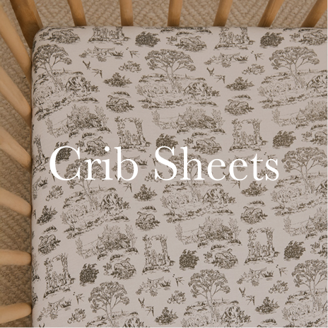 Crib sheet with nature-themed pattern on a crib