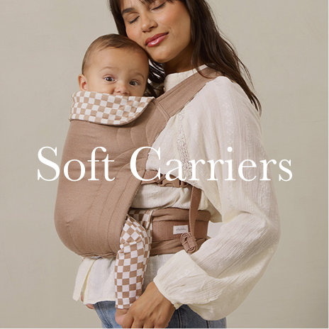 Woman holding a baby in a soft carrier with text 'Soft Carriers' on a beige background