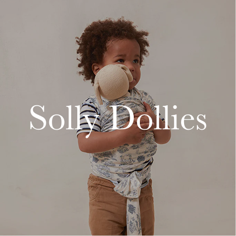 Child holding a plush toy with 'Solly Dollies' text overlay on a plain background