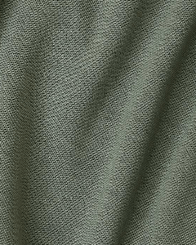 A close-up of olive green textured fabric with soft folds and a fine woven pattern.
