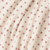 A close-up of red twinkle star fabric pattern.