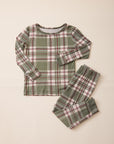 A two-piece long-sleeve pajama set featuring a green, white, and red plaid pattern, laid flat on a light beige background.