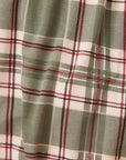 A close-up of a plaid fabric pattern with sage green, cream, and burgundy stripes.