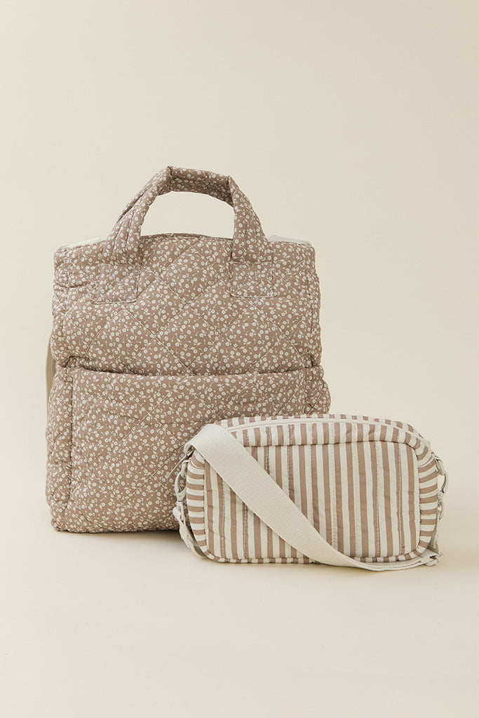 Solly Baby Cream Floral Totepack diaper bag featuring a delicate cream and taupe floral print with small crossbody bag in a matching cream and taupe striped print. 