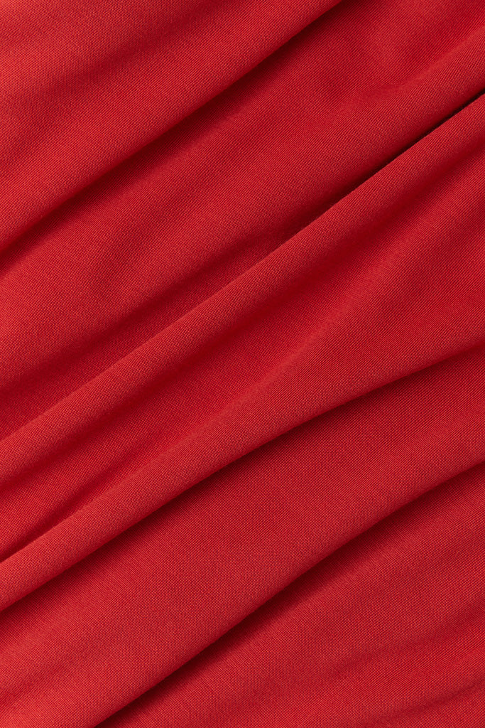 : A close-up fabric shot of Solly Baby&#39;s Currant colorway, a vibrant holiday red.