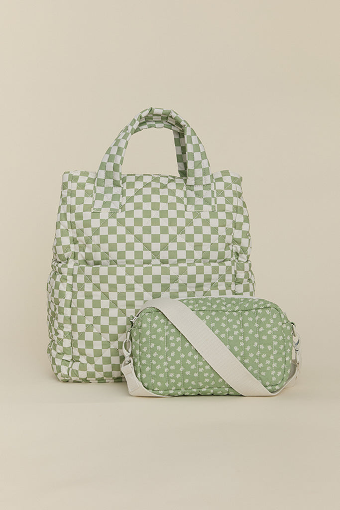 Solly Baby Fern Chequer Totepack diaper bag featuring a soft green and cream checkered print with small crossbody bag in a matching soft green and cream floral print. 