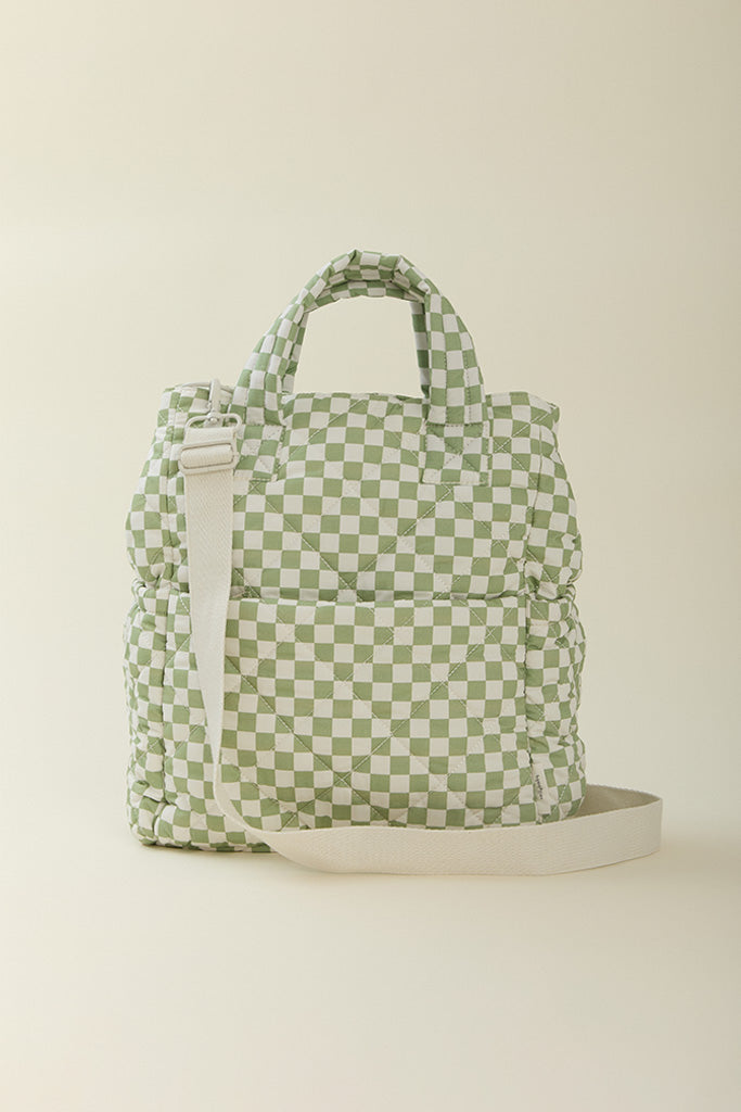 A back-view of the Solly Baby Fern Chequer Totepack diaper bag featuring an adjustable strap.