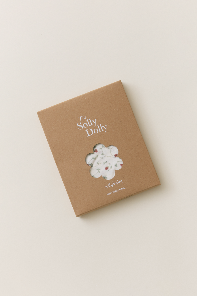 Solly Dolly in a kraft box with a floral cutout window revealing the dainty hand-painted strawberry vine fabric.